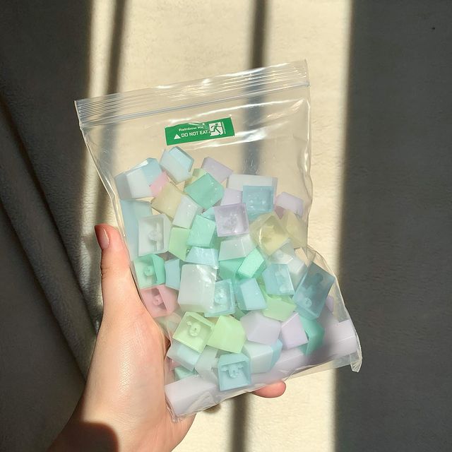 bag of pastel POM jelly keycaps in the sunlight